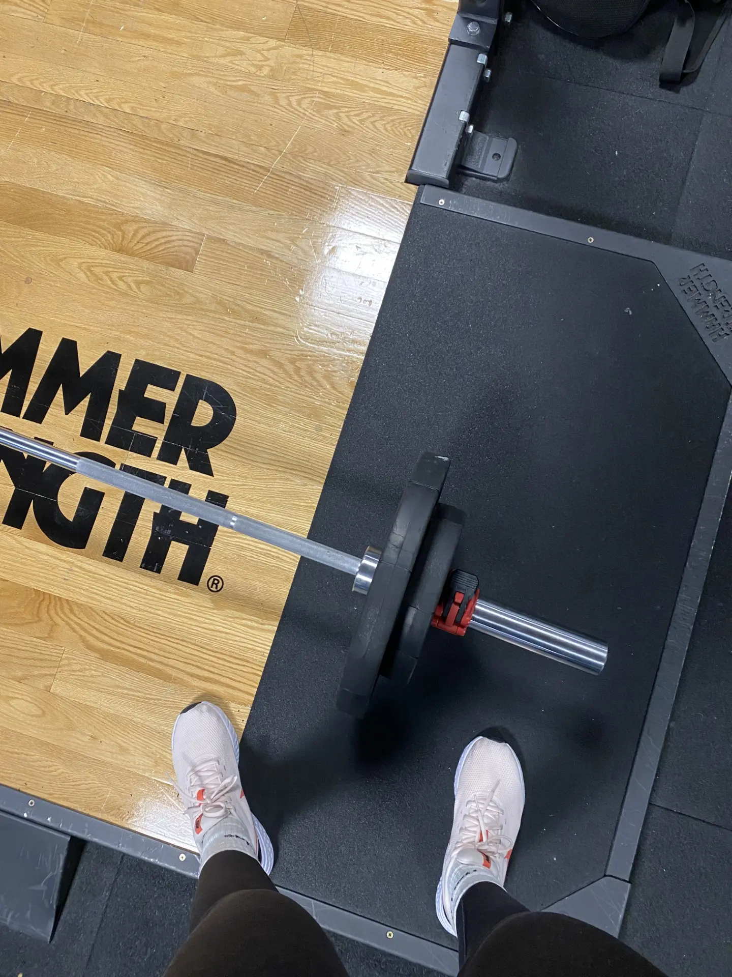 Loaded barbell on a lifting platform seen from above