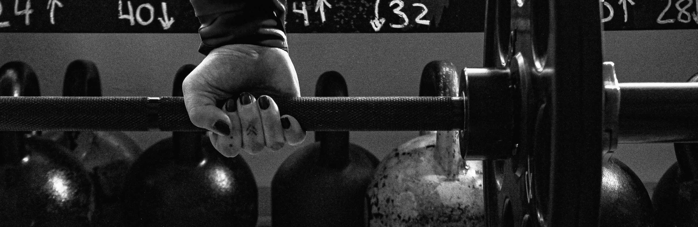 Close-up of a barbell being loaded with plates
